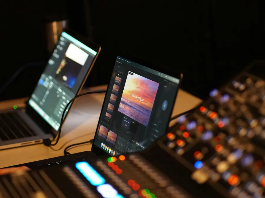 Verse Copilot open on a laptop next to the sound board in a dark booth